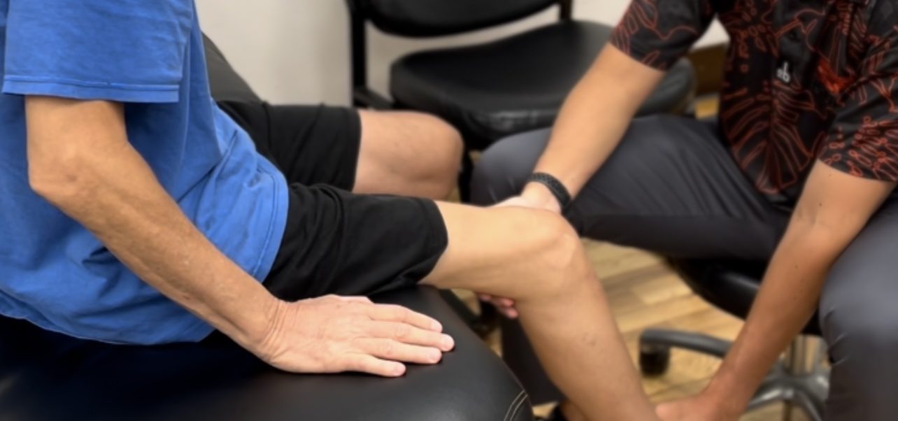 Therapist examining a patient's knee